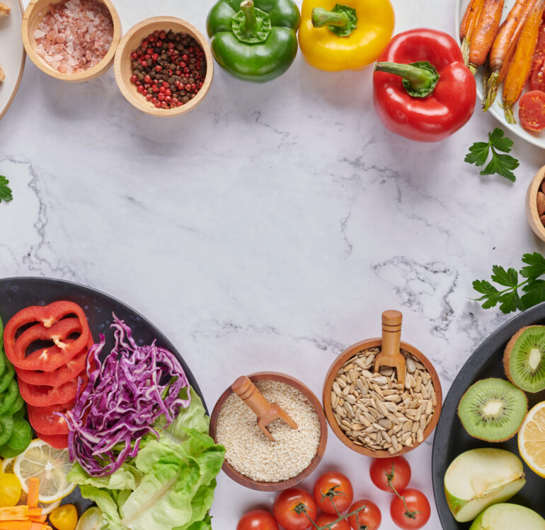 Vegan protein source. Buddha bowl dish, avocado, pepper, tomato, cabbage, chickpea, toast, bread fresh lettuce salad and walnuts, nuts, beans. Healthy vegetarian eating, super food. Top view.